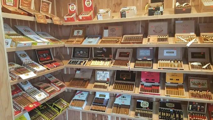 Wooden shelves displaying a variety of cigar boxes in different colors and sizes